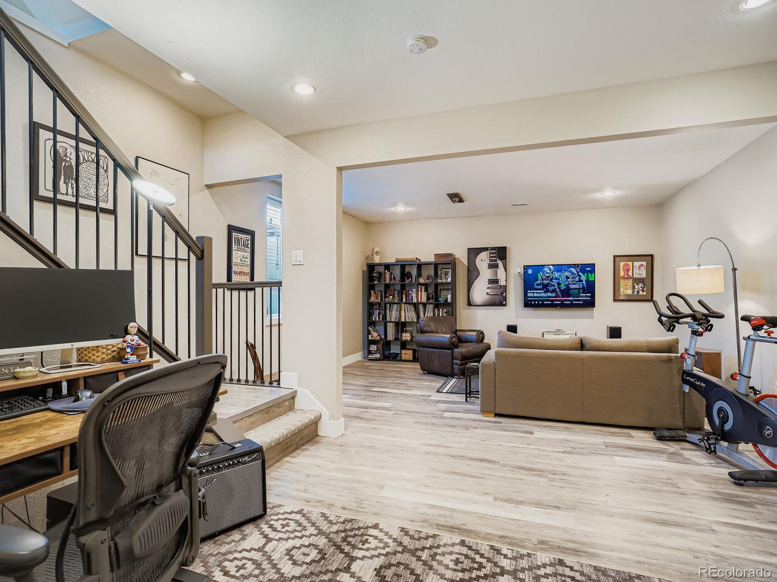 15506 W Lane Lakewood, CO 80228 - Photo 25 of 37 a living room with furniture and a flat screen tv