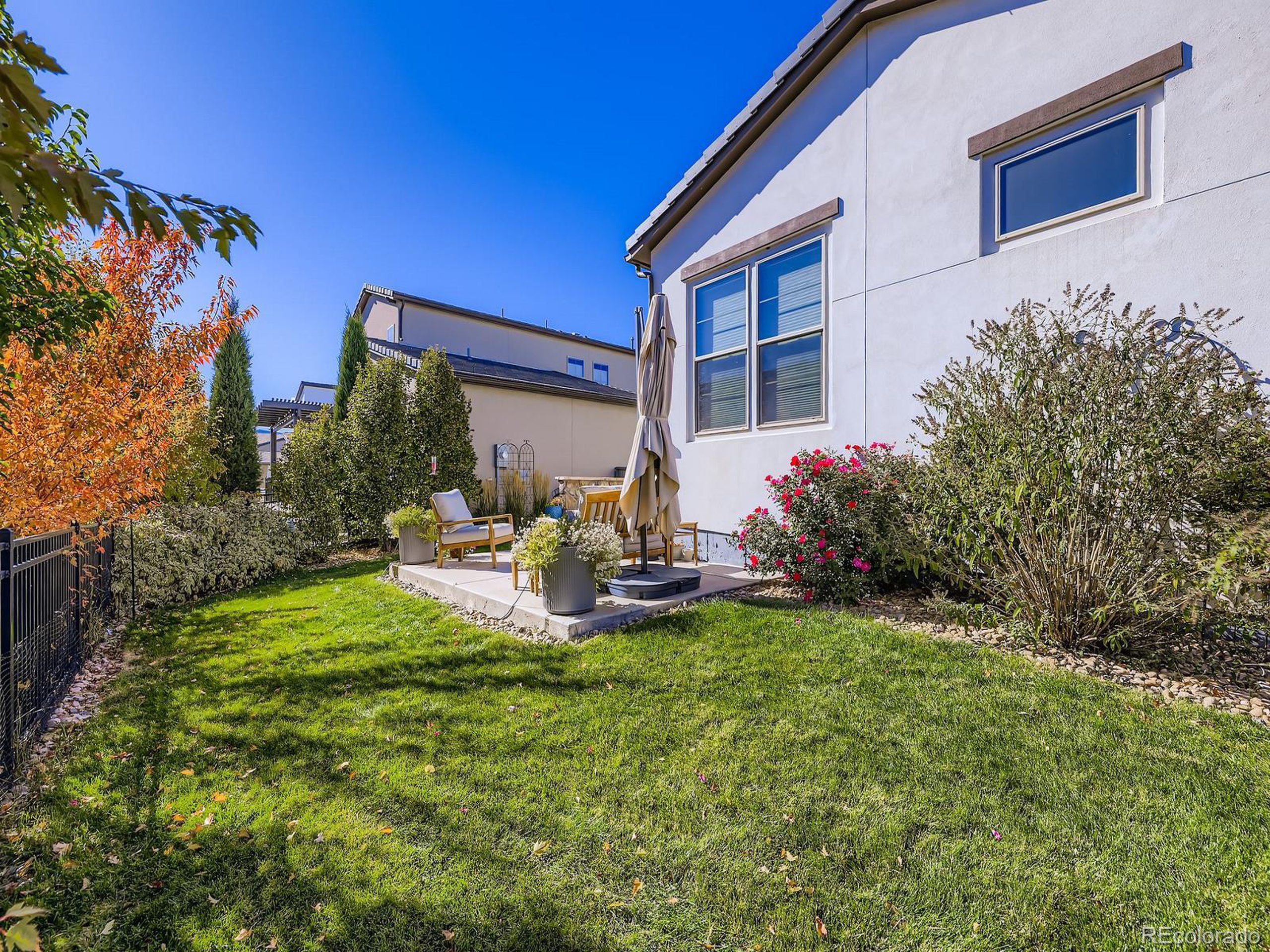 15506 W Lane Lakewood, CO 80228 - Photo 32 of 37 a view of a house with backyard sitting area and garden