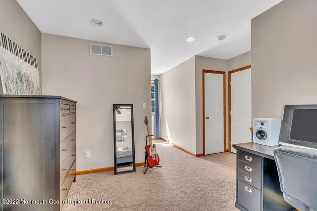 a bedroom with a bed window and a desk