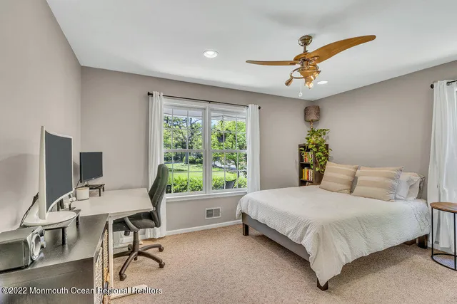 a bedroom with a large bed and a window