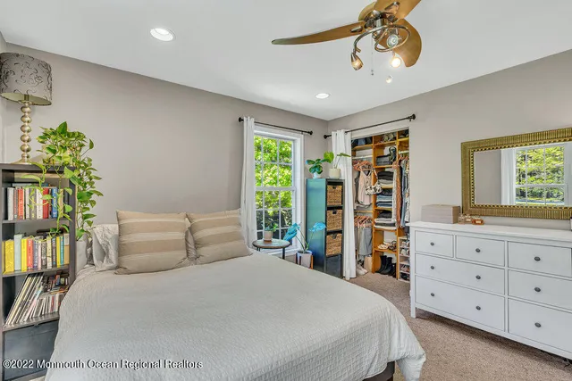 a bedroom that has a bed and a desk in it