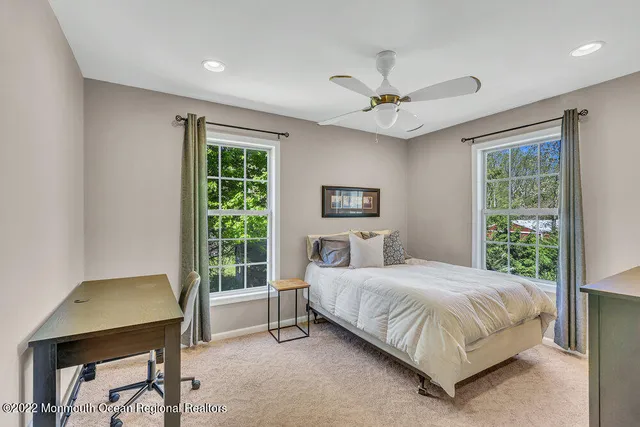 a bedroom with a bed and a large mirror