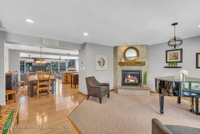 a living room with furniture a fireplace and a table