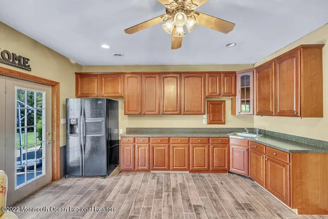a living room with furniture a flat screen tv and a large window