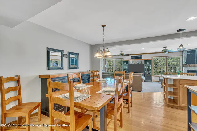 a dining room with furniture window and wooden floor
