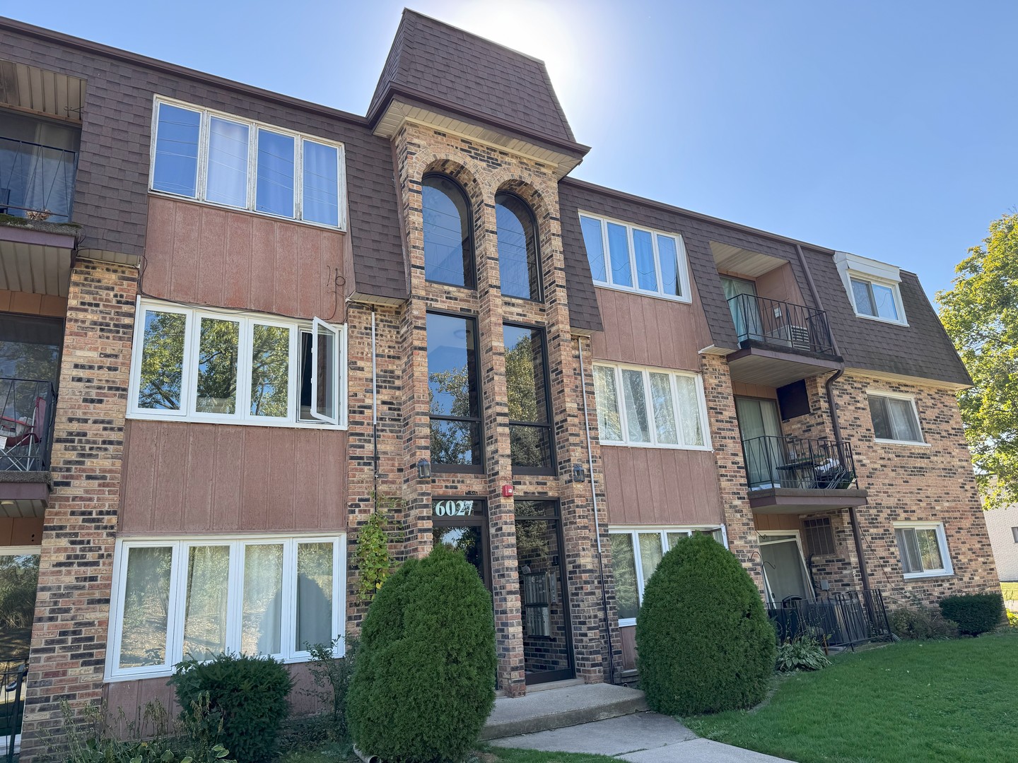 a front view of a house with a garden