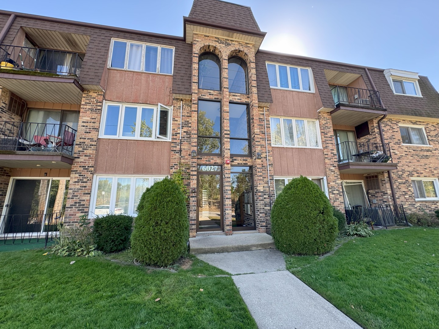 6027 103rd Street, Unit 1A Chicago Ridge, IL 60415 - Photo 7 of 7 a view of a brick house with a yard and plants