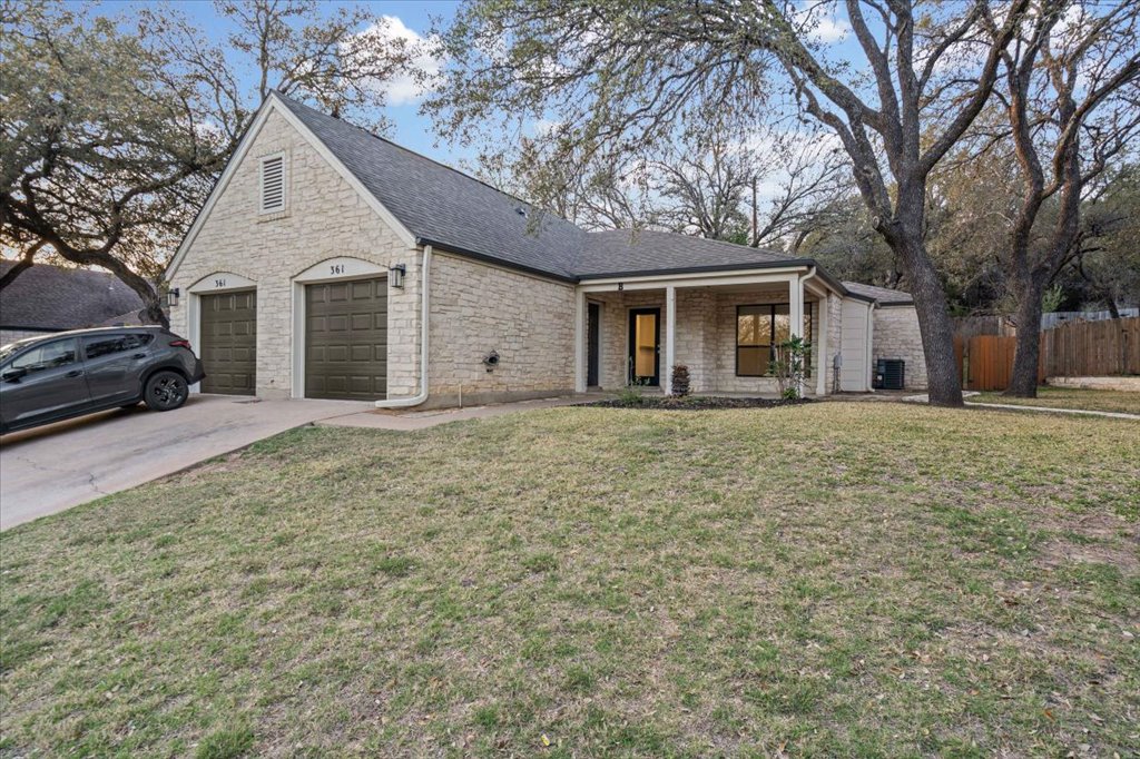 361 Fantail Loop, Unit B Austin, TX 78734 - Photo 1 of 29 a front view of a house with large trees