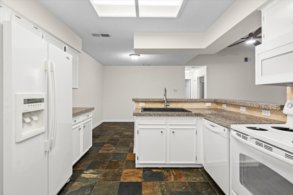 361 Fantail Loop, Unit B Austin, TX 78734 - Photo 14 of 29 a kitchen with a sink stove and cabinets