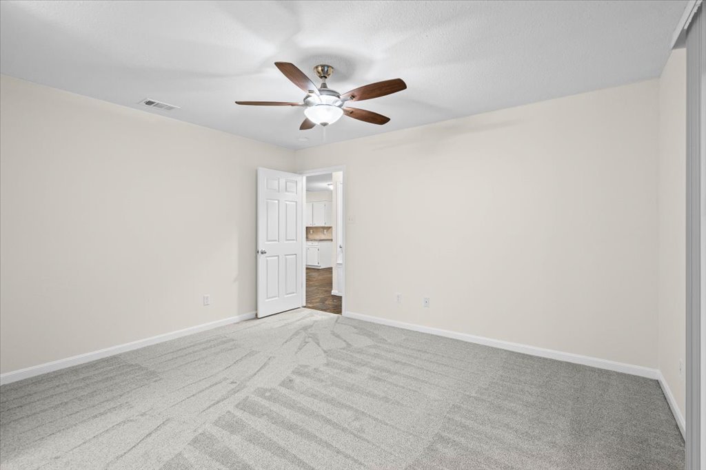 361 Fantail Loop, Unit B Austin, TX 78734 - Photo 17 of 29 a view of empty room with window and ceiling fan