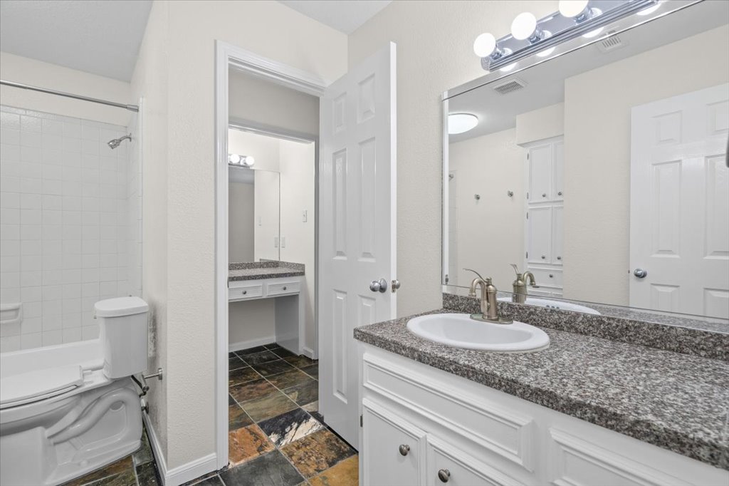 361 Fantail Loop, Unit B Austin, TX 78734 - Photo 22 of 29 a bathroom with a sink double vanity granite and a toilet