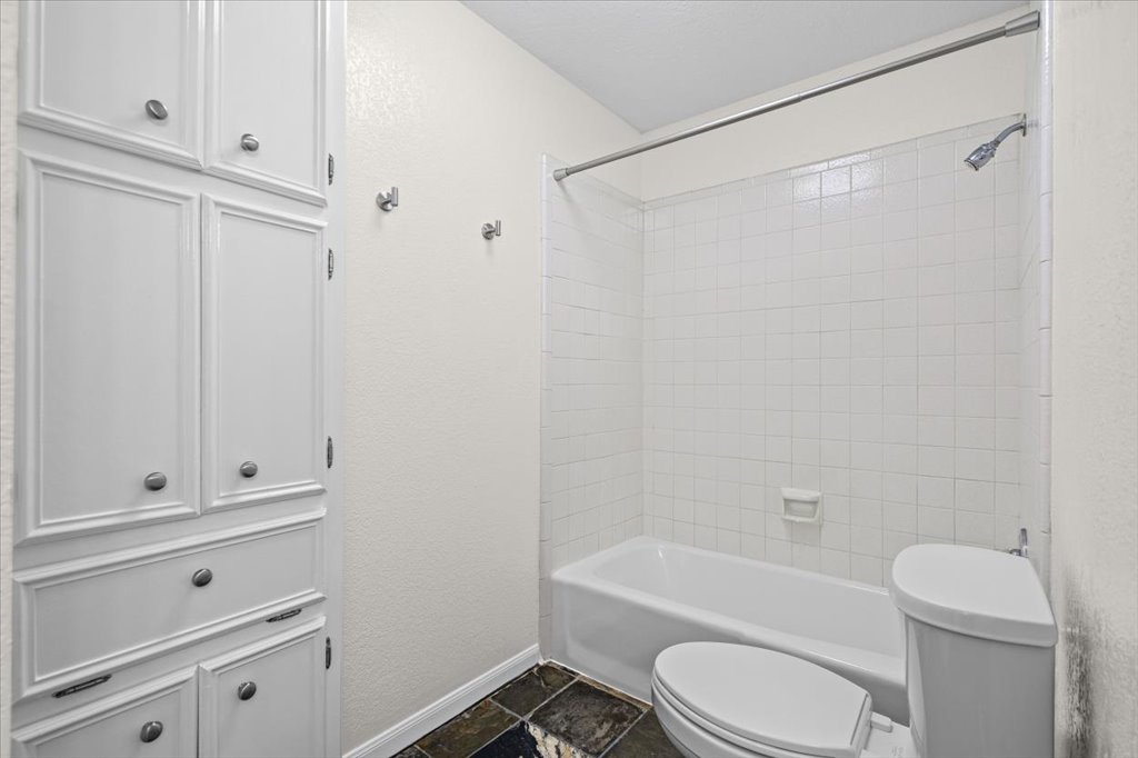 361 Fantail Loop, Unit B Austin, TX 78734 - Photo 24 of 29 a white toilet sitting next to a bathroom sink