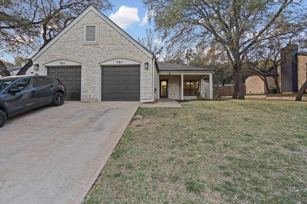 361 Fantail Loop, Unit B Austin, TX 78734 - Photo 3 of 29 a front view of a house with a yard and garage