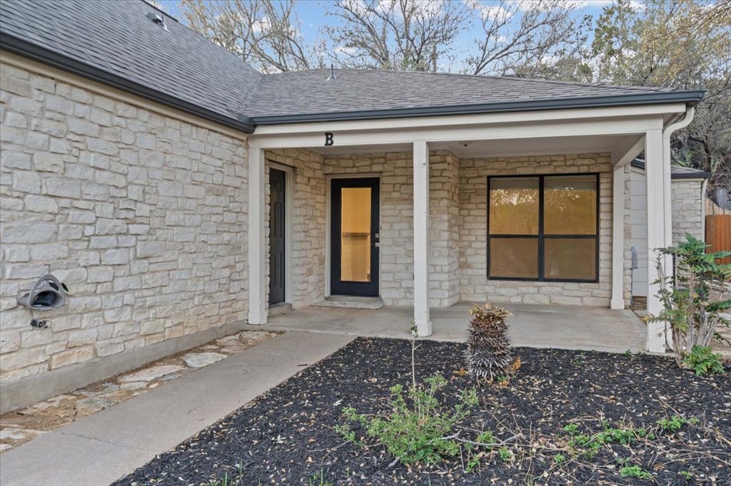 361 Fantail Loop, Unit B Austin, TX 78734 - Photo 4 of 29 a front view of a house with a yard