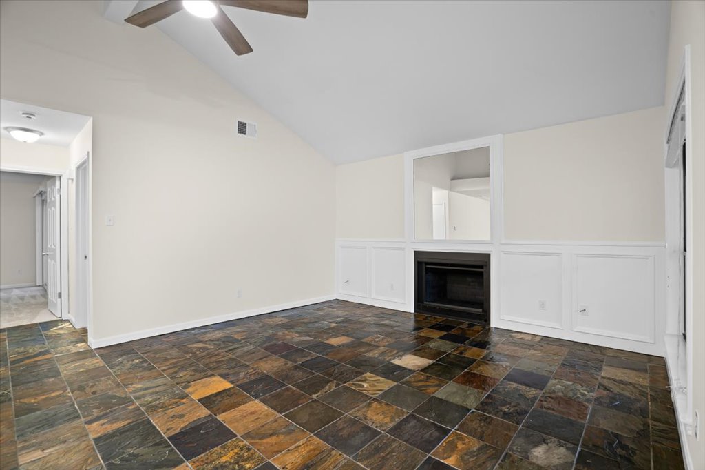 361 Fantail Loop, Unit B Austin, TX 78734 - Photo 6 of 29 an empty room with windows and fireplace