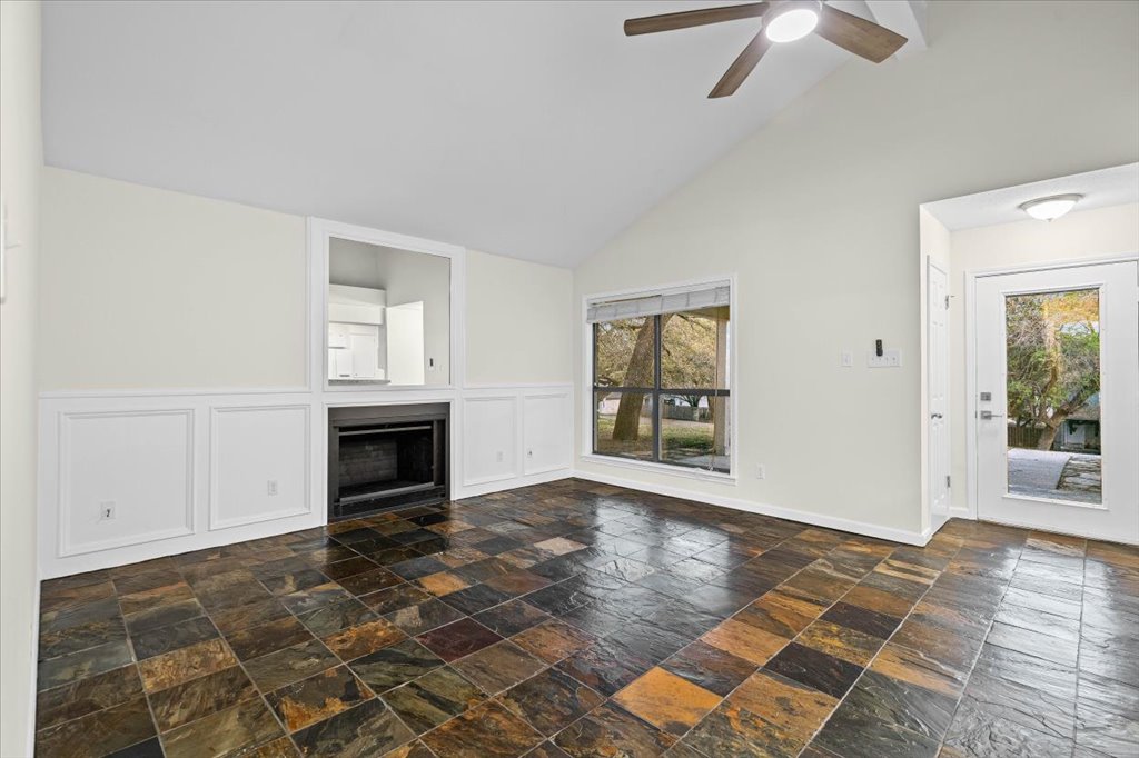 361 Fantail Loop, Unit B Austin, TX 78734 - Photo 7 of 29 an empty room with windows and fireplace