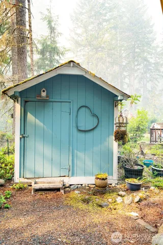 a backyard of a house with a yard and outdoor seating