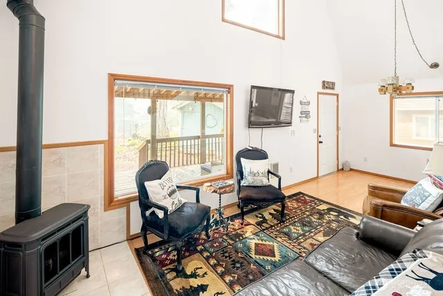 a kitchen with a refrigerator a stove a sink dishwasher with a dining table and chairs