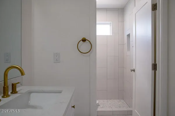 a bathroom with a sink mirror and toilet