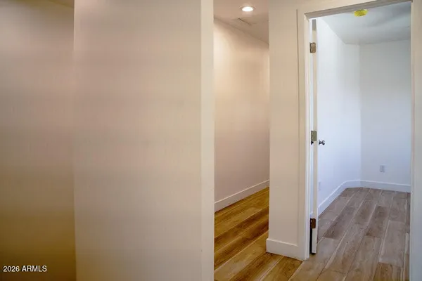 a view of a hallway with wooden floor