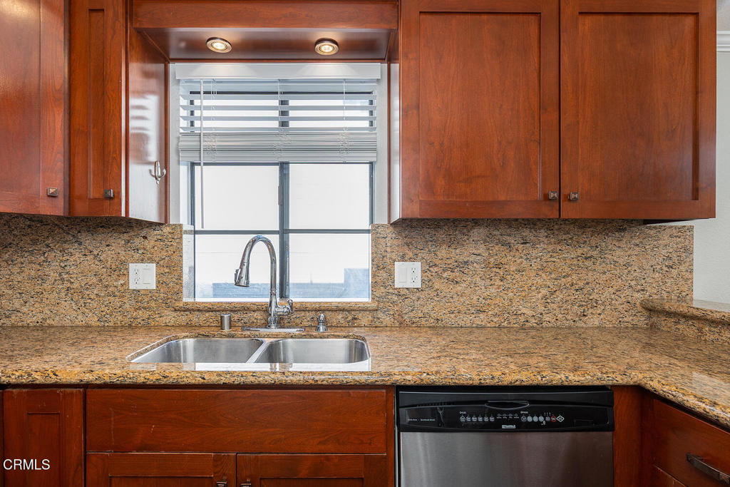 249 Alpine Street, Unit 44 Pasadena, CA 91106 - Photo 11 of 23 a kitchen with granite countertop cabinets washer and dryer