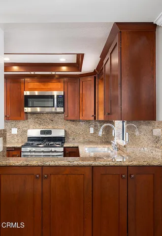 a bathroom with a granite countertop toilet sink and mirror