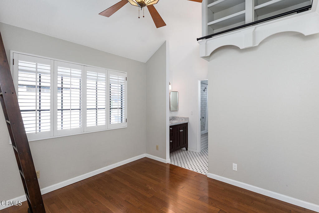249 Alpine Street, Unit 44 Pasadena, CA 91106 - Photo 20 of 23 an empty room with wooden floor cabinet and windows