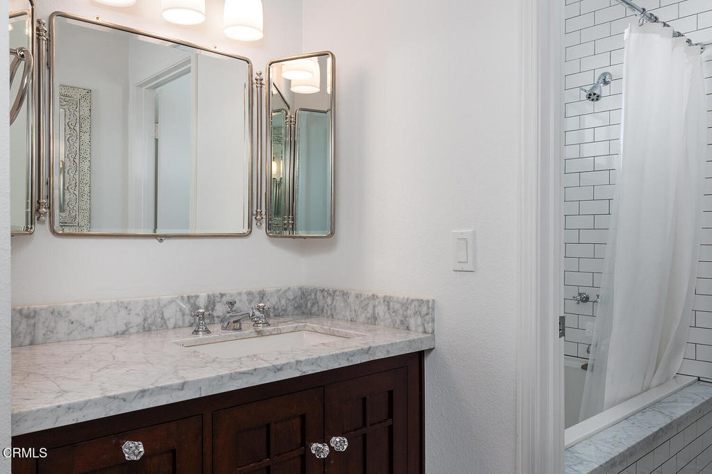 249 Alpine Street, Unit 44 Pasadena, CA 91106 - Photo 21 of 23 a bathroom with a granite countertop sink and a mirror