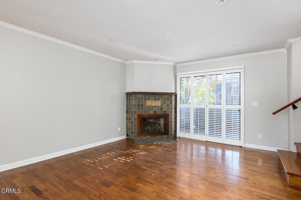 249 Alpine Street, Unit 44 Pasadena, CA 91106 - Photo 3 of 23 an empty room with wooden floor and windows