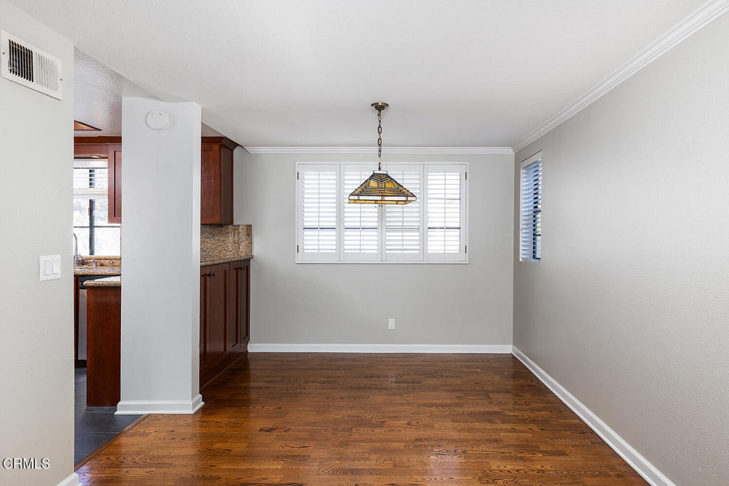 249 Alpine Street, Unit 44 Pasadena, CA 91106 - Photo 7 of 23 a view of empty room with wooden floor and fan