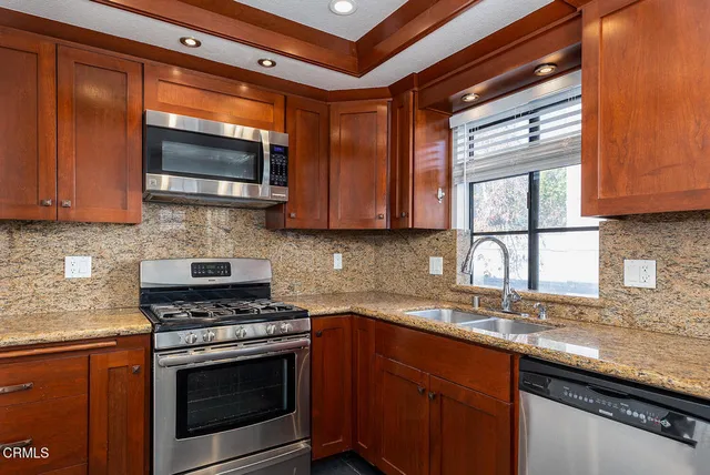a kitchen with granite countertop cabinets washer and dryer