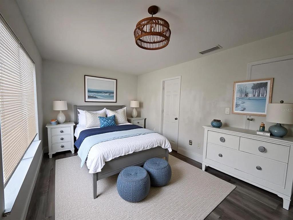 4033 Henley Road, Unit 1707 Orlando, FL 32839 - Photo 14 of 66 a bed room with a bed and a chandelier