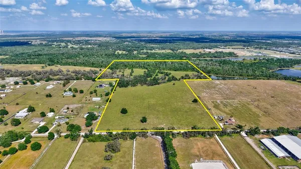 a view of a swimming pool with a yard and outdoor seating