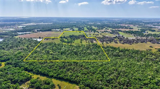 an aerial view of a houses with a yard