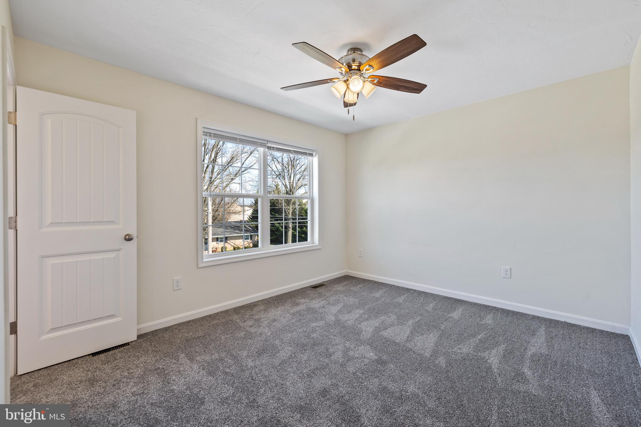 824 Rising Sun Lane Chambersburg, PA 17202 - Photo 14 of 25 an empty room with windows and fan
