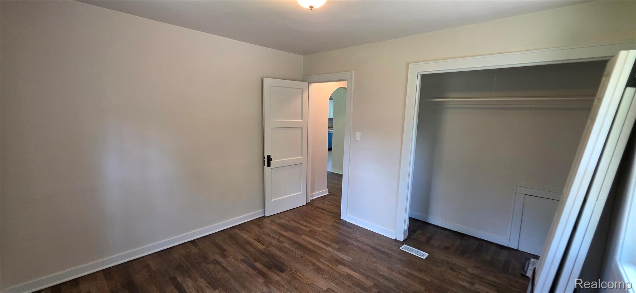 9205 Neff Road Clio, MI 48420 - Photo 13 of 35 Room featuring wood-finish flooring, white baseboards, and a neutral wall color