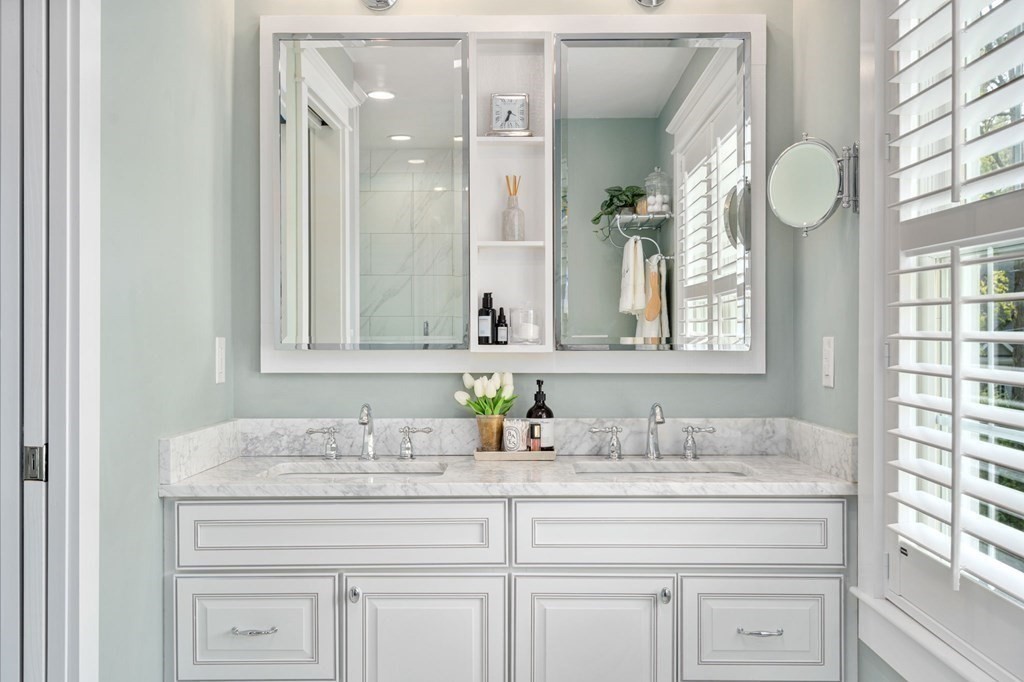3 Colby Road Wellesley, MA 02482 - Photo 13 of 25 a bathroom with cabinets a granite countertop sink and a mirror