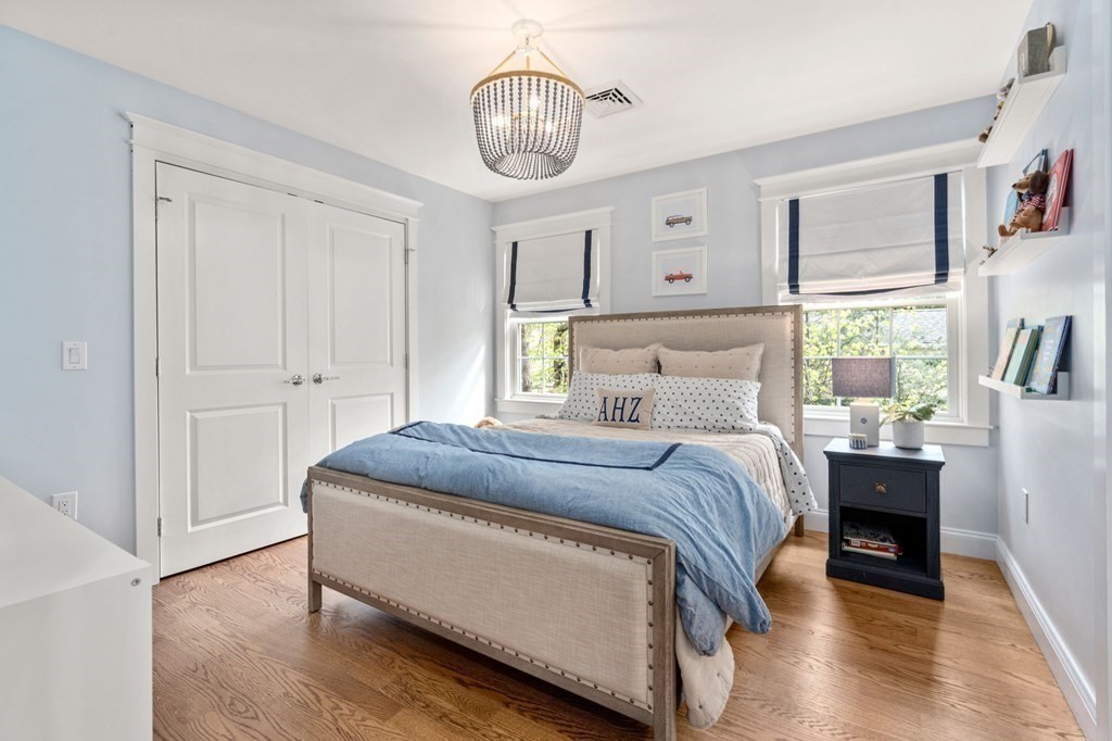 3 Colby Road Wellesley, MA 02482 - Photo 17 of 25 a bedroom with a bed chandelier and a window