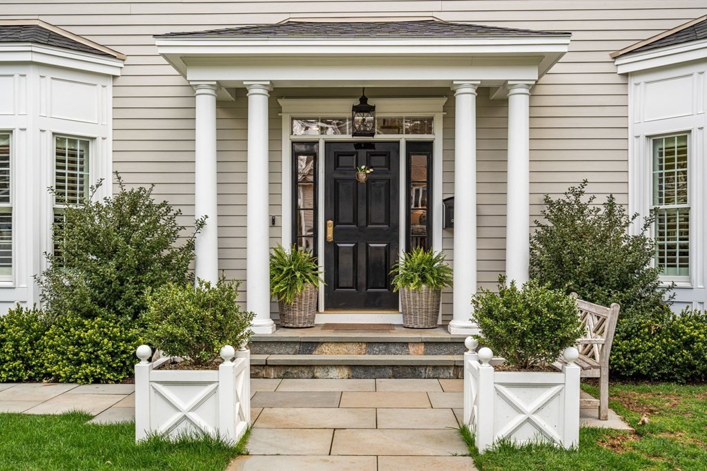 3 Colby Road Wellesley, MA 02482 - Photo 24 of 25 a view of a house with potted plants and a table and chair