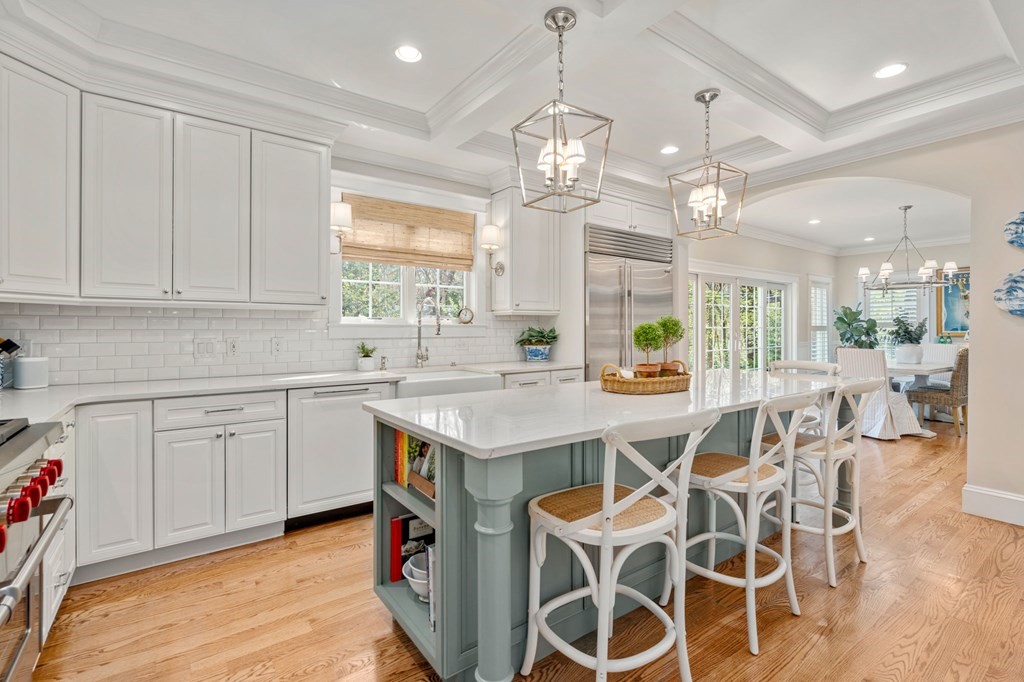 3 Colby Road Wellesley, MA 02482 - Photo 4 of 25 a open kitchen with stainless steel appliances granite countertop a dining table chairs and white cabinets