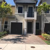 a house with palm tree in front of it