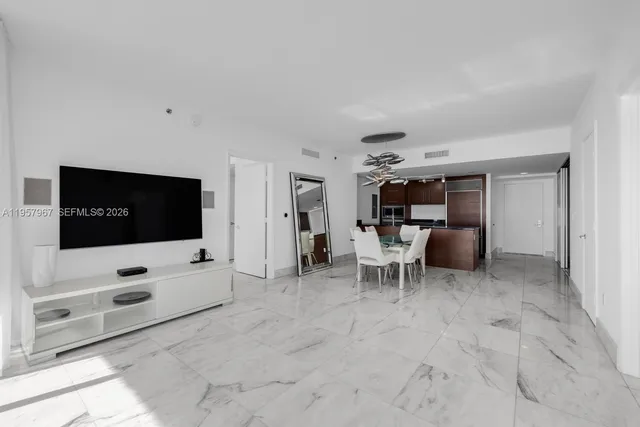 a living room with flat screen tv and white floor