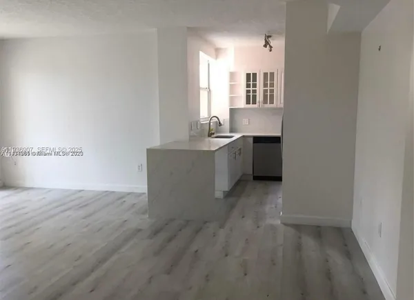 a view of a kitchen with a sink and dishwasher