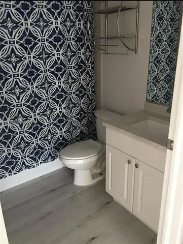 a white toilet sitting next to a shower curtain