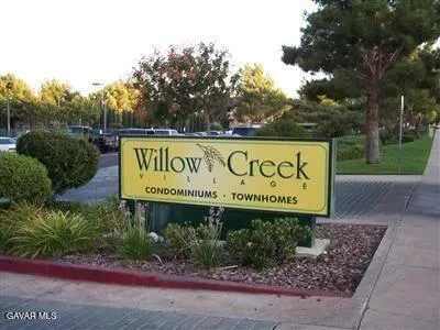 a sign broad in front of the tree