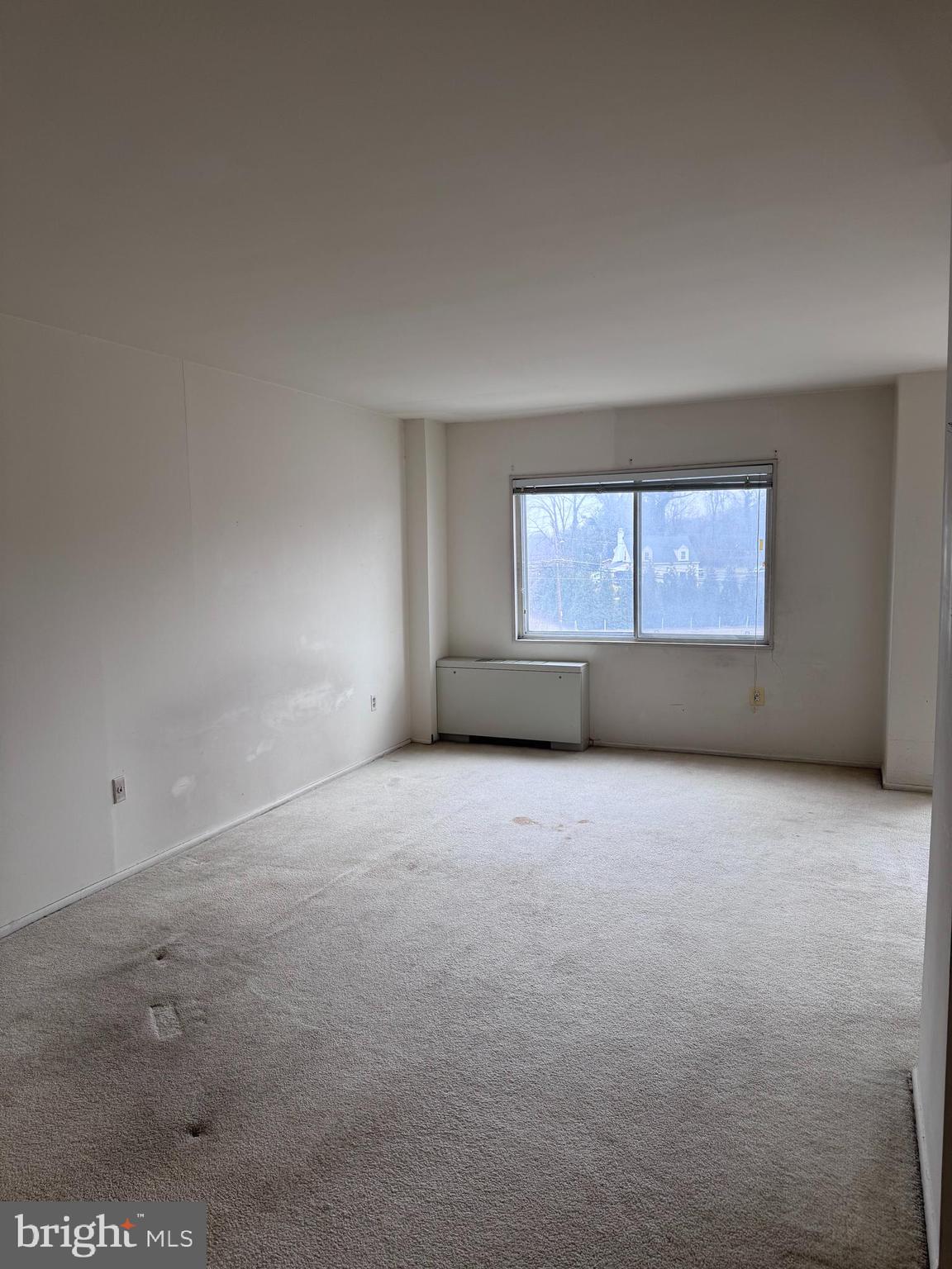 1111 University Boulevard West, Unit 402 Silver Spring, MD 20902 - Photo 6 of 15 an empty room with a window
