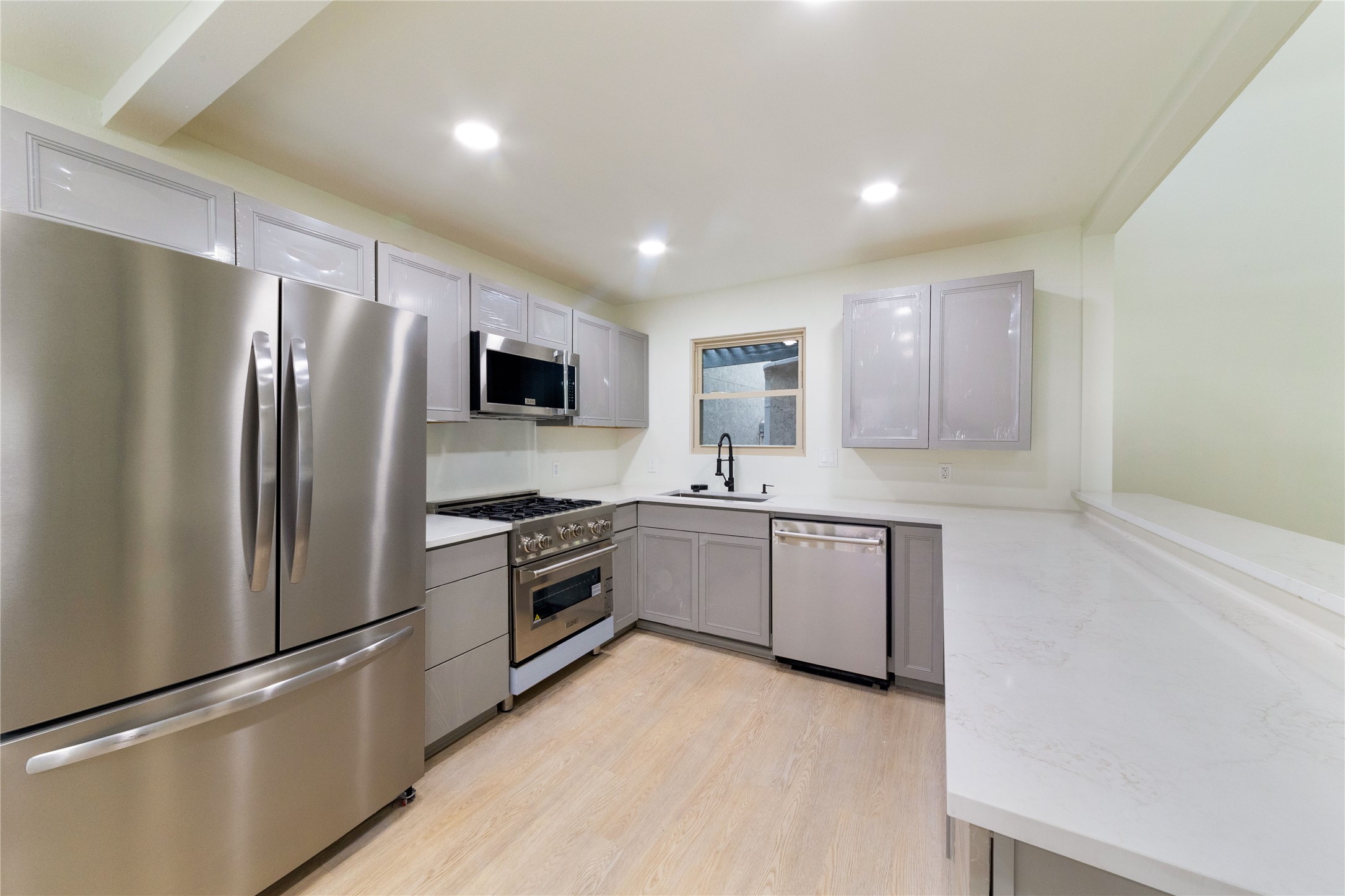 8807 Merion Circle Austin, TX 78754 - Photo 6 of 18 Culinary delights await in this sleek kitchen featuring stainless steel appliances and light wood flooring.