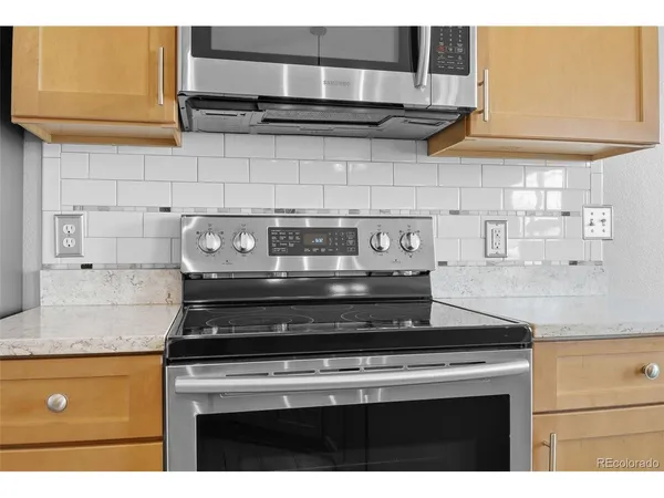 a stove top oven sitting inside of a kitchen