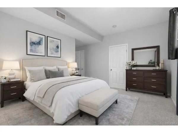 a bedroom with a bed and a dresser