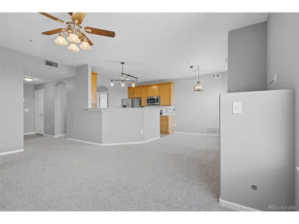 a view of a kitchen with a kitchen and a ceiling fan